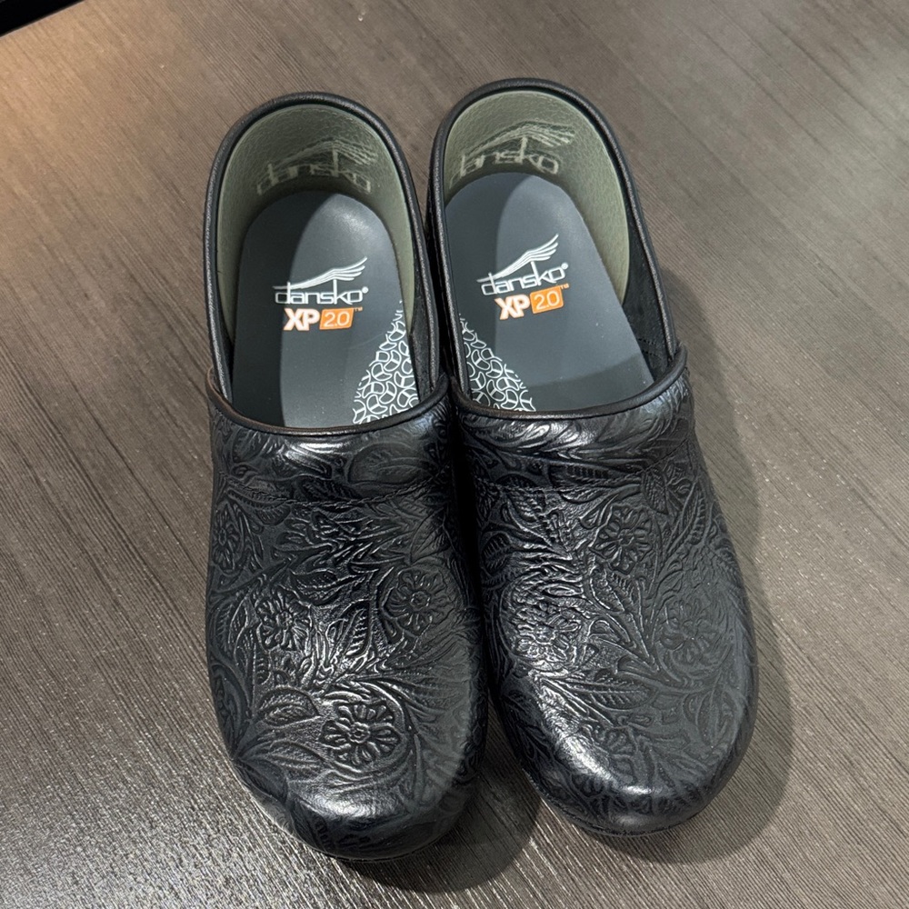 Dansko Black Floral Embossed Clogs